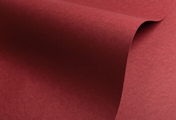 Deep burgundy paper background with a matte, grainy texture and subtle fibrous surface. Rich red...