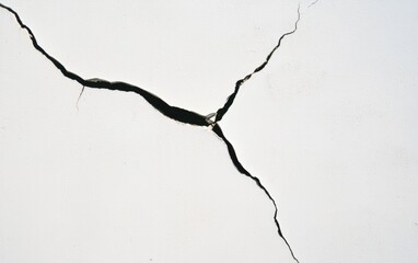 Close Up Of A Y Shaped Crack On A White Wall Surface