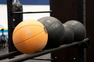 Orange and black medicine balls on rack at gym at Bosön