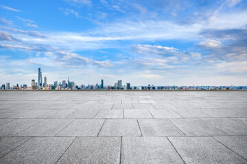 Fototapeta premium Empty stone floor and Shanghai cityscape with skyline at blue sky