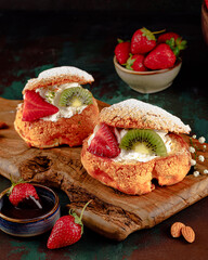 Fruity profiteroles served on a dark background