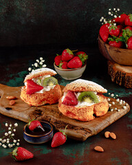 Fruity profiteroles served on a dark background