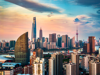 Obraz premium Shanghai skyline with modern skyscrapers and dramatic sky at sunset