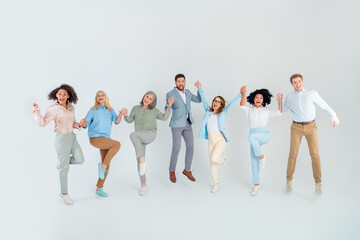 Obraz premium Group of professional colleagues joyfully interacting in a modern office setting, multi-age