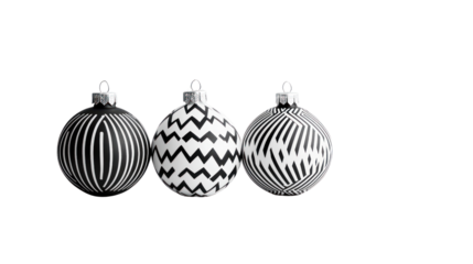 Three decorative black and white Christmas ornaments with unique patterns on a white isolated background.