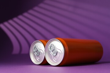 Two tin cans on purple background with shadow, closeup. Space for text