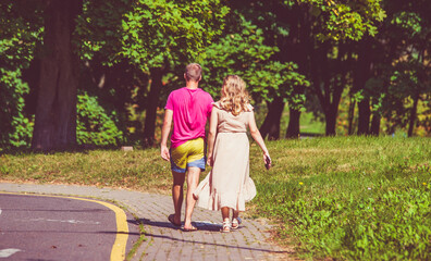 Fototapeta premium A man and a woman walk in a summer park 