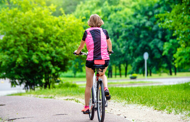 Fototapeta premium Cyclist ride on the bike path in the city Park 