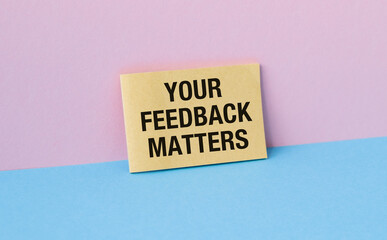 Feedback concept. Paper Card with text Your feedback matters on pink background. Message symbol...