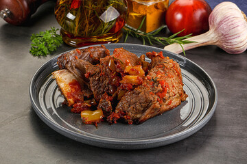 Baked beef ribs with vegetables