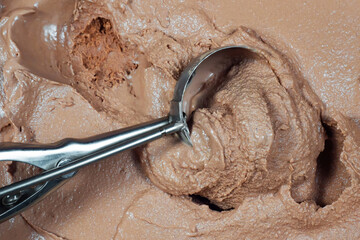 Scoop of chocolate ice cream with scoop, close-up