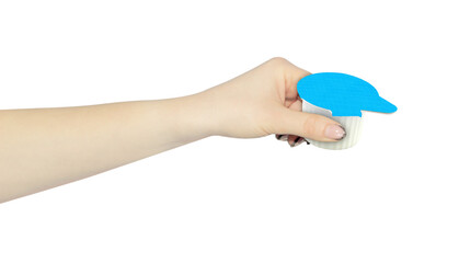 Portion packs with cream in hand, outstretched hand with portion packs with creamisolated from...