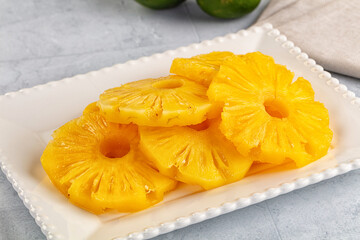 Sweet canned pineapple slices in syrope