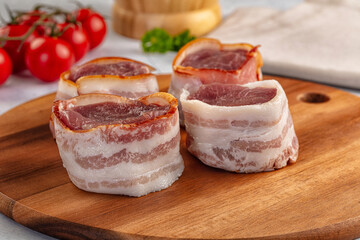 Raw pork tenferloin with bacon