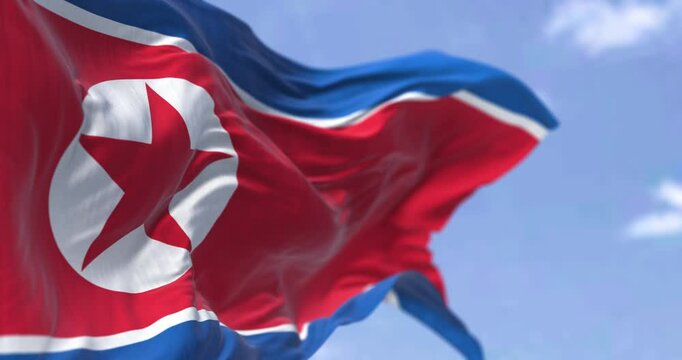 Close-up of North Korea national flag waving in the wind on a clear day