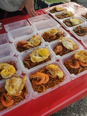 Vendor selling cuisine at street bazaar in Malaysia catered for iftar during Muslim fasting month of Ramadan