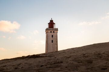 Abandoned lighthouse on sandy dune at sunset, Rubjerg Knude, Denmark