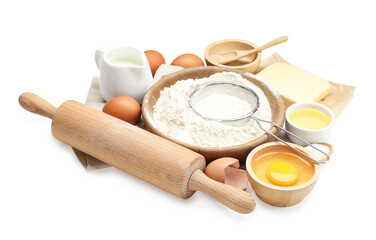 Rolling pin and different ingredients isolated on white