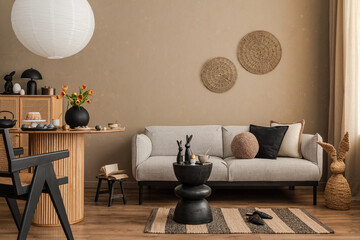 A warm and inviting living space with soft textiles, rattan details, and sculptural décor. Earthy...