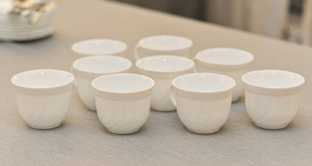 Empty white coffee cups sit on clean table, highlighting simplicity and minimalism. image captures the essence of coffee-themed setting, perfect for themes of relaxation, cafes, and everyday moments.