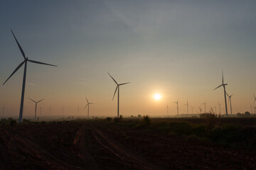 Obraz premium Wind turbines generate electricity at sunset in Europe and Asia