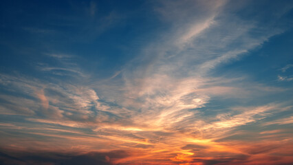 Awesome sunset and soft pink clouds of pastel tones. Image template of textured sky. Bright epic sky. Dramatic evening light and fiery orange sunset.