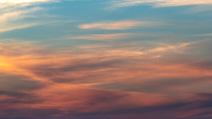 Awesome sunset and soft pink clouds of pastel tones. Image template of textured sky. Bright epic sky. Dramatic evening light and fiery orange sunset.