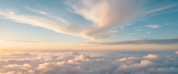The morning sky appeared like a bright golden hue. The sunrise is adorned with clouds in various shapes. It looks beautiful.