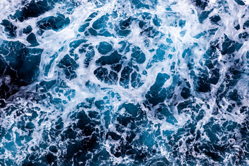 Ocean surface texture. Top view of stunning water with foam. Can be used in covers, packaging, posters, textures, banners, art, and design projects. Beautiful nature background image.