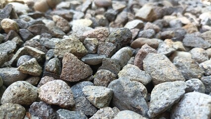 Gray gravel stones for the construction industry. Gravel stones near the railway track. Texture. Background