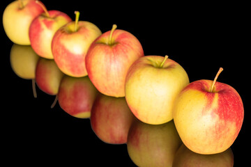Ripe juicy apples isolated on black background, macro.