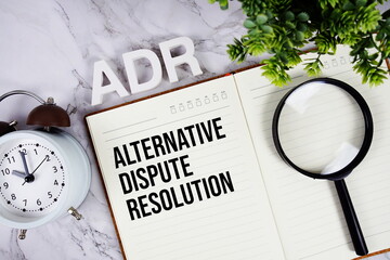 ADR - Alternative Dispute Resolution acronym on notepad, Business concept background