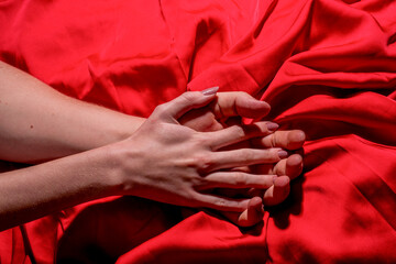 Couple sensual touch. Hands of lovers. Woman pulling sheets. Hands of love. Couple in love. Sensual hands concept. Tender couple in bed. Romance.