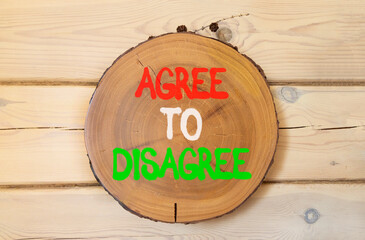Agree to disagree symbol. Concept words Agree to disagree on beautiful wooden circle. Beautiful...