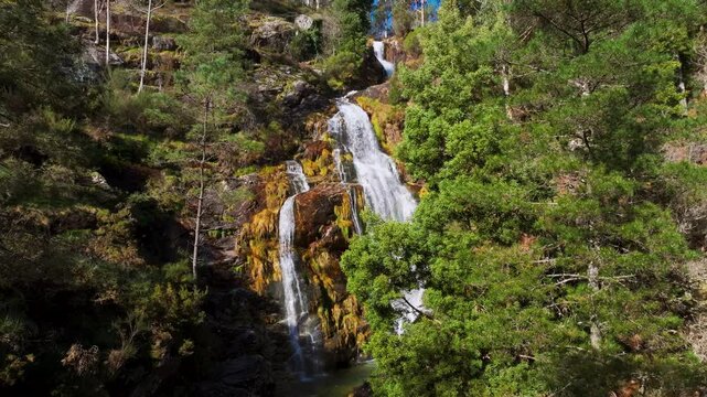 Cadarnoxo Waterfall Cascading Through Mossy Rocks In Boiro, A Coruna, Spain. sliding shot