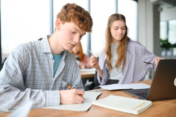 Obraz premium students sitting in a classroom, studying, discussing