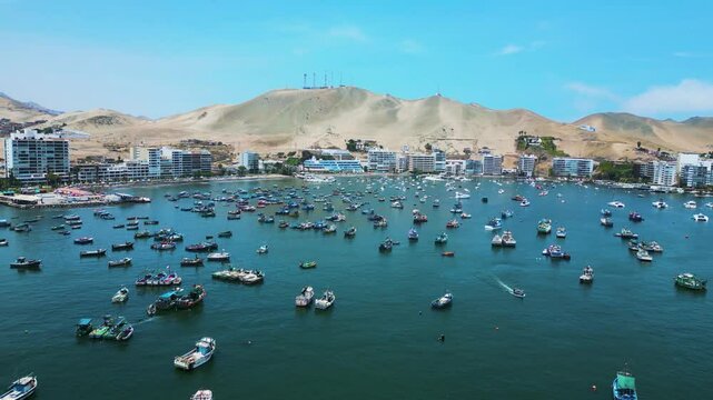 Aerial view of Ancon Beach, Lima, Peru, with boats scattered across the sea on a bright summer day.
