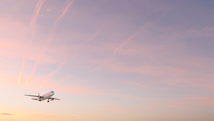 ULTRA HD. Airplane flies in sunset sky. Travel. Airplane takes off against the background of sunset sky.