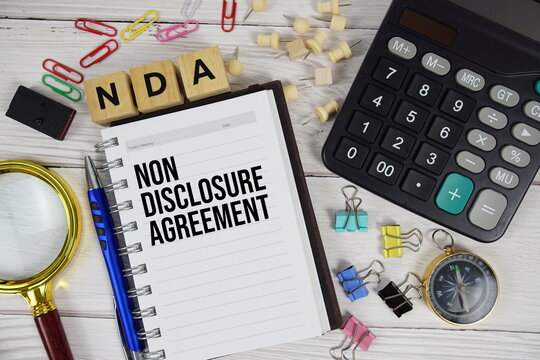 NDA - Non Disclosure Agreement acronym on notepad, business and financial concept background