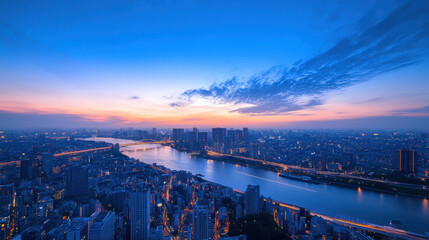 Fototapeta premium stunning high angle view of Japanese city skyline at dusk, showcasing vibrant lights reflecting on river. scene captures beauty of urban life and nature tranquility