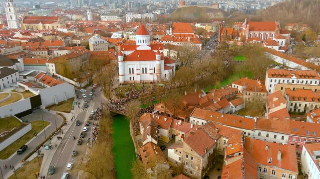 Aerial view of hundreds of people enjoying festivities and celebrating St. Patrick's day in Vilnius. Vilnele river was dyed green to mark the patron saint of Ireland's day.