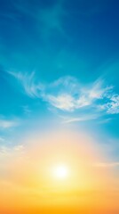 Obraz premium Vibrant sunset sky with bright sun and wispy cirrus clouds creating dramatic atmosphere against gradient from deep blue to warm orange and yellow horizon.