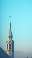 Obraz premium Majestic cathedral with spires and a cross under a cloudy sky at sunrise.