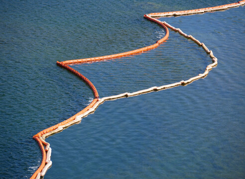 Construction site at sea - water surface divided into wavy less wavy and calm