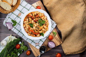 Lobio is a dish of Georgian, Azerbaijani and Armenian cuisines made from green bean pods. Traditional Georgian cuisine lobio. Lean dish. Lobio with pepper, onion. Top view. Flatlay