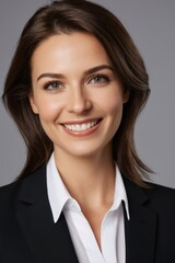 smiling woman in black suit and white shirt with long hair