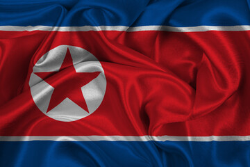 Realistic flag of North Korea on the wavy surface of fabric. National Day North Korea September 9th.