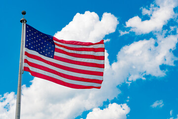 American flag waving for independence day. Flag of the USA. National waving flag of united states on blue sky. Independence day. Patriotic symbol. American Flag for Memorial Day or 4th of July