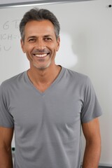 Obraz premium smiling man in front of a whiteboard with writing on it