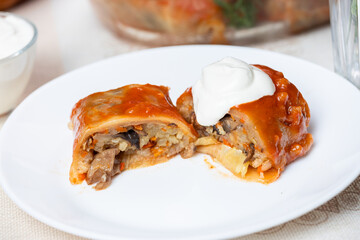 Stuffed cabbage rolls with mushrooms and sour cream in a cut. Stuffed cabbage rolls with mushrooms. Traditional Ukrainian cuisine.